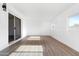 Bright living room with light wood vinyl flooring and sliding glass doors with windows at 13624 N 31St Ave, Phoenix, AZ 85029
