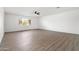 Spacious living room with light wood vinyl flooring, bright windows, and neutral colored walls at 13624 N 31St Ave, Phoenix, AZ 85029