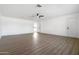 Spacious living room with light wood vinyl flooring, bright lighting, and neutral colored walls at 13624 N 31St Ave, Phoenix, AZ 85029