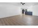 Open and airy living space with stylish wood floors, a modern ceiling fan, and a connected kitchen area at 13624 N 31St Ave, Phoenix, AZ 85029