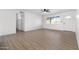 Open living space with wood floors and a large window, leading to a bright entryway and a modern kitchen at 13624 N 31St Ave, Phoenix, AZ 85029