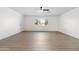 Bright living room with light wood vinyl flooring, bright windows, and neutral colored walls at 13624 N 31St Ave, Phoenix, AZ 85029