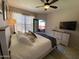 Bedroom with a large window, ceiling fan, and a door to the balcony at 14950 W Mountain View Blvd # 2210, Surprise, AZ 85374