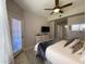 Well-lit bedroom with access to the outside, dresser, mounted TV, and decorative rug at 14950 W Mountain View Blvd # 2210, Surprise, AZ 85374