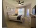 Comfortable bedroom with neutral tones, stylish decor, and natural light from the window and door at 14950 W Mountain View Blvd # 2210, Surprise, AZ 85374