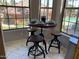 Bright breakfast nook with counter-height table, four stools, and views of community pool at 14950 W Mountain View Blvd # 2210, Surprise, AZ 85374