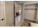 Hallway with neutral colors and a storage area featuring a bench and coat hooks at 14950 W Mountain View Blvd # 2210, Surprise, AZ 85374