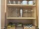 Organized cabinet featuring martini glasses, cups, coffee supplies, and tea for an inviting beverage station at 14950 W Mountain View Blvd # 2210, Surprise, AZ 85374