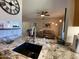 Modern kitchen featuring granite countertops, stainless steel appliances, and ample natural light at 14950 W Mountain View Blvd # 2210, Surprise, AZ 85374