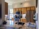 Modern kitchen with wood cabinets, stainless steel appliances, and granite countertops at 14950 W Mountain View Blvd # 2210, Surprise, AZ 85374