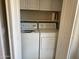 Convenient laundry closet featuring a white washer and dryer with built-in shelving at 14950 W Mountain View Blvd # 2210, Surprise, AZ 85374