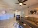 Comfortable living room with neutral tones, stylish decor, tile floors and ample seating at 14950 W Mountain View Blvd # 2210, Surprise, AZ 85374