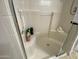 Clean white shower with built-in seating, shower caddy, and a convenient grab bar at 14950 W Mountain View Blvd # 2210, Surprise, AZ 85374