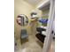 A well-organized walk-in closet with shelving, a mirror, and a chair offers optimal storage at 14950 W Mountain View Blvd # 2210, Surprise, AZ 85374