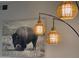 Stylish wall decor featuring a textured light fixture and a captivating buffalo art piece at 14950 W Mountain View Blvd # 2210, Surprise, AZ 85374