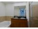 Bathroom with tub, granite countertop, dual sinks, and glass-enclosed shower at 16 W Encanto Blvd # 305, Phoenix, AZ 85003