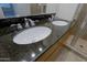 Bathroom featuring dual sinks, a dark countertop, and a glass-enclosed shower at 16 W Encanto Blvd # 305, Phoenix, AZ 85003