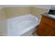 Bathroom featuring a soaking tub, a dark countertop, and vanity with stainless steel fixtures at 16 W Encanto Blvd # 305, Phoenix, AZ 85003