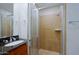 Bathroom featuring a shower stall, vanity with granite countertop, and stainless steel sink at 16 W Encanto Blvd # 305, Phoenix, AZ 85003