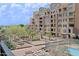 Building exterior and courtyard with lush landscaping and a pool at 16 W Encanto Blvd # 305, Phoenix, AZ 85003