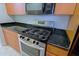Stainless steel gas range and oven with black granite countertops at 16 W Encanto Blvd # 305, Phoenix, AZ 85003