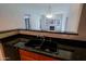 Kitchen sink with stone countertops with open view to the living room and fireplace at 16 W Encanto Blvd # 305, Phoenix, AZ 85003