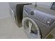 Modern laundry room with front-load washer and dryer set, offering efficient laundry convenience at 16 W Encanto Blvd # 305, Phoenix, AZ 85003