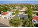 Aerial shot of home shows the roof, landscaping, nearby neighborhood, and mountain views in the distance at 16227 N 63Rd Pl, Scottsdale, AZ 85254