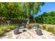 Cozy backyard with a fire pit, comfortable seating, and lush landscaping for relaxation and outdoor enjoyment at 16227 N 63Rd Pl, Scottsdale, AZ 85254