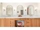 Elegant bathroom vanity with marble countertop, arched mirrors, and a comfortable pink stool at 16227 N 63Rd Pl, Scottsdale, AZ 85254