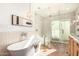 Bright bathroom featuring a freestanding tub, glass enclosed shower, and contemporary fixtures at 16227 N 63Rd Pl, Scottsdale, AZ 85254