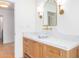 Elegant bathroom featuring marble countertops, wooden cabinets, and sconce lighting at 16227 N 63Rd Pl, Scottsdale, AZ 85254