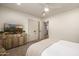 Bright bedroom with soft carpet, white walls, a large window, and stylish wooden cabinet at 16227 N 63Rd Pl, Scottsdale, AZ 85254