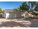 Charming single-story home featuring a large garage and mature landscaping at 16227 N 63Rd Pl, Scottsdale, AZ 85254