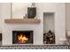 Close-up of the fireplace with a tiled base, wooden mantle, and decorative accents at 16227 N 63Rd Pl, Scottsdale, AZ 85254