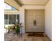 Elegant double front doors with travertine tile, covered porch, and charming accents at 16227 N 63Rd Pl, Scottsdale, AZ 85254
