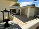 Charming front porch with double doors, stone pavers, and tasteful landscaping creates an inviting entrance to the home at 16227 N 63Rd Pl, Scottsdale, AZ 85254