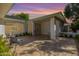 Charming home exterior featuring a tiled front patio with seating under a covered entryway at 16227 N 63Rd Pl, Scottsdale, AZ 85254