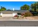 Charming single-story home boasts desert landscaping, mature trees, and a two-car garage at 16227 N 63Rd Pl, Scottsdale, AZ 85254