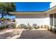 Relaxing front patio with tiled flooring, outdoor seating, and lush greenery at 16227 N 63Rd Pl, Scottsdale, AZ 85254