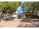 Charming single-story home with a well-maintained yard and mature trees at 16227 N 63Rd Pl, Scottsdale, AZ 85254