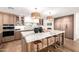 Bright kitchen features a marble waterfall island, stainless steel appliances, and custom wood cabinetry at 16227 N 63Rd Pl, Scottsdale, AZ 85254