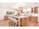 Bright kitchen features a large island with marble countertop and seating, complemented by wooden cabinets and modern appliances at 16227 N 63Rd Pl, Scottsdale, AZ 85254
