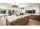 Beautiful kitchen island with white marble countertop and wooden drawers, perfect for food preparation at 16227 N 63Rd Pl, Scottsdale, AZ 85254