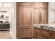 Modern kitchen featuring wood cabinetry and stainless steel refrigerator in an open-concept design at 16227 N 63Rd Pl, Scottsdale, AZ 85254