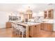 Bright kitchen features a marble island with seating, wood cabinets, and modern appliances at 16227 N 63Rd Pl, Scottsdale, AZ 85254