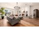 Bright living room with large windows, a cozy fireplace, and hardwood floors at 16227 N 63Rd Pl, Scottsdale, AZ 85254