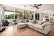 Open-concept living room featuring a large sectional, hardwood floors, and a backyard view at 16227 N 63Rd Pl, Scottsdale, AZ 85254