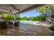 Covered patio overlooking a pool with seating, landscaping, and outdoor entertaining space at 16227 N 63Rd Pl, Scottsdale, AZ 85254
