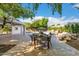 Outdoor patio with dining table, pool, lounge chairs, and mature trees offering ample shade at 16227 N 63Rd Pl, Scottsdale, AZ 85254